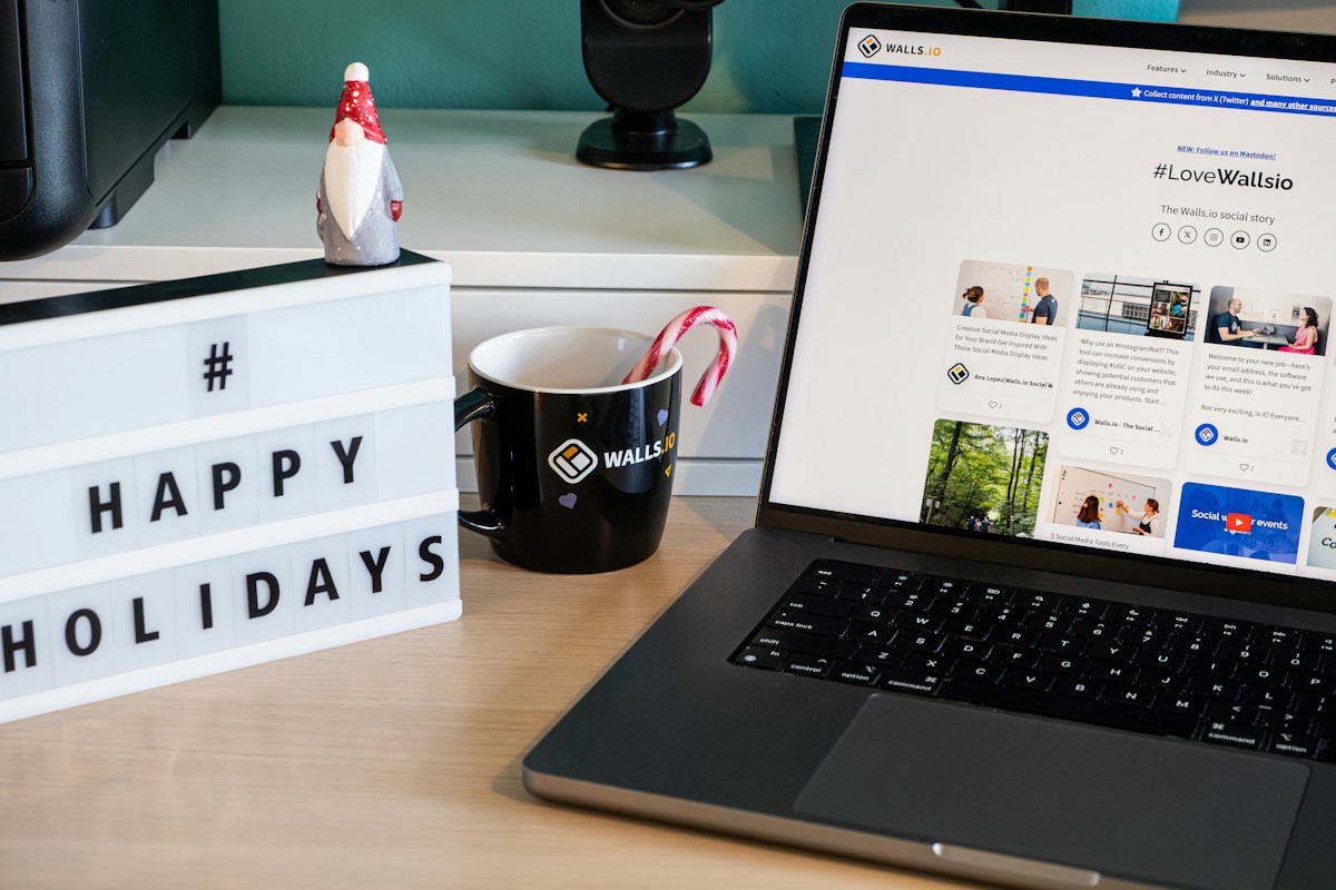 Laptop with holiday decorations showing Q4 advertising planning for ecommerce brands